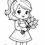 Dziewczynka z liśćmi w rękach na trawie